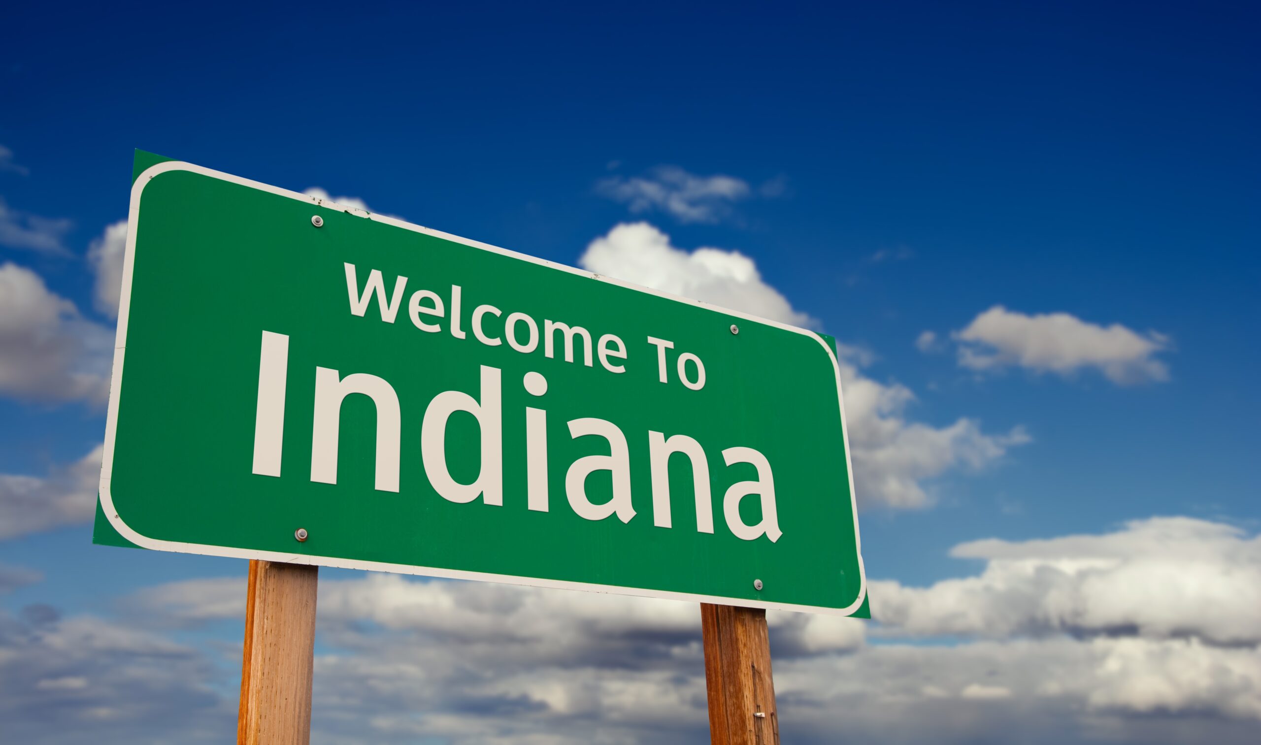Welcome,To,Indiana,Green,Road,Sign,Over,Blue,Sky,With